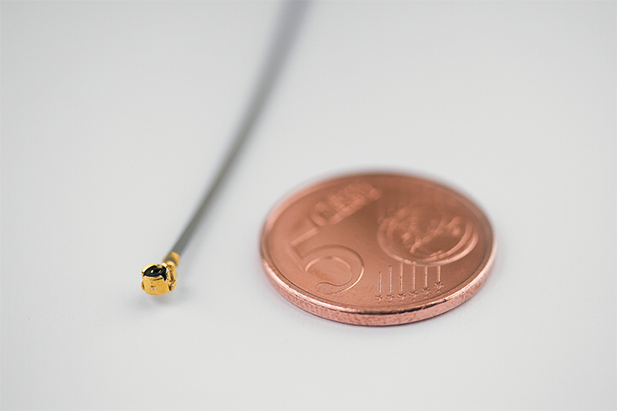 Size comparison UMTC connector and coin 